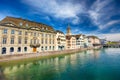 Beautiful view of the historic city center of Zurich with famous Fraumunster Church and swans on river Limmat on a sunny day