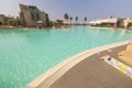 Beautiful view of hotel`s outdoor pool. Outdoor bar and hotel buildings on cloudless blue sky background. Royalty Free Stock Photo