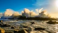 Beautiful view of a huge wave breaking rocks during sunrise Royalty Free Stock Photo