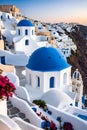 Beautiful view of the iconic whitewashed buildings of Santorini, with cobalt-blue domes, cliff, sunset, travel, Greek island Royalty Free Stock Photo