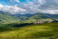 Beautiful view of idyllic alpine mountain scenery with blooming meadows and mountains on a beautiful sunny day with blue sky and