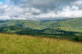 Beautiful view of idyllic alpine mountain scenery with blooming meadows and mountains on a beautiful sunny day with blue sky and Royalty Free Stock Photo