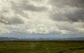 Beautiful view of idyllic landscape in the Alps with fresh green meadows and mountain tops a sunny day with blue sky and clouds in Royalty Free Stock Photo