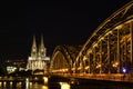 Beautiful view of illuminated Hohenzollern Bridge and Cologne Cathedral at night in Cologne, Germany Royalty Free Stock Photo