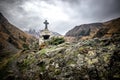 Beautiful view on impressive gorge in Caucasus mountains. Monument in form of Cross and path to it