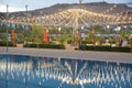 Beautiful view of Infinity Swimming Pool . cloud reflections on the infinity pool . Blurred of restaurant with light