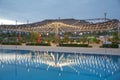 Beautiful view of Infinity Swimming Pool . cloud reflections on the infinity pool . Blurred of restaurant with light Royalty Free Stock Photo