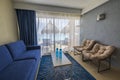 Beautiful view of interior hotel room and  patio outside though light curtains. Turquoise water surface of Atlantic Ocean Royalty Free Stock Photo