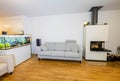 Beautiful view of interior of modern living room. White fireplace, big aquarium with colorful fishes.