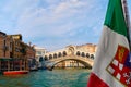 Beautiful view of Italian maritime flag and bridge of Rialto or ponte Rialto on Grand Canal on Venice, Italy. Gondola