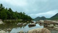 Beautiful view of Jordan Pond in mountains against a green forest Royalty Free Stock Photo