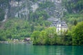 Beautiful view of lake Brienz with medieval european style castle on small village and fresh green forest background