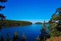 Beautiful view of lake with islands covered in green forest. Pine trees on the shore under a clear, blue sky. The concept of a Royalty Free Stock Photo