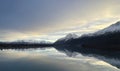 Beautiful view of a lake with the reflection of the snow-covered mountains at sunset