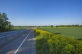 Beautiful view of landscape with green fields, highway road, green forest trees and blue sky. Royalty Free Stock Photo