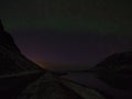 Light green shimmering polar light in the dark, starry night sky above ÃÂlftafjÃÂ¶ÃÂ°ur fjord, SnÃÂ¦fellsnes, Iceland.