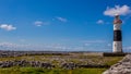 Beautiful view of the lighthouse on the rocky limestone coast of the island Inis Oirr