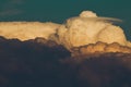 Beautiful view of a long wispy cloud drifting across the sky above a layer of fluffy white clouds