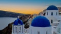 Beautiful view of look out with sunset sky scene background and blue dome church at Oia village, Santorini,Greec