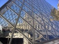 Beautiful view of the Louvre - Pyramid glazed stairs and people transiting inside