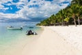 Beautiful view of the luxury beach in Mauritius. Transparent ocean, white sand beach, palms and sky Royalty Free Stock Photo