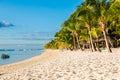 Beautiful view of the luxury beach in Mauritius. Transparent ocean, white sand beach, palms and sky Royalty Free Stock Photo