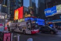 Beautiful view of Manhattan night with double-decker tour bus on road. New York. Royalty Free Stock Photo