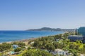 Beautiful view of Mediterranean sea sand beach with sun beds and sun umbrellas and hotel buildings on background. Rhodes. Royalty Free Stock Photo