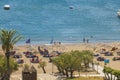 Beautiful view of Mediterranean sea sand beach with sunbeds and sun umbrellas. Rhodes. Royalty Free Stock Photo