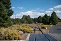 Beautiful view of metal train tracks through the forest on daytime Royalty Free Stock Photo