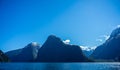 Beautiful view of Milford Sound with Mitre Peak on the foreground and snow capped mountains in the background taken on a sunny