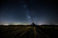 Beautiful view of milky way over a cultivated field and distant Royalty Free Stock Photo