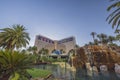 Beautiful view of The Mirage casino hotel with a pond and tropical trees.