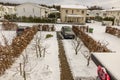 Beautiful view of modern village with parked cars in private parking lots in winter day.