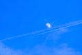 Beautiful view of a moon still visible on the vibrant blue sky during daytime Royalty Free Stock Photo