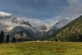 Beautiful view of morning foggy mountain landscape. Remote house surrounded by wild nature,meadows,pasture,Alps.Rural lifestyle in
