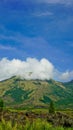Beautiful view of Mount Guntur with white clouds against a bright blue sky Royalty Free Stock Photo