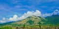 Beautiful view of Mount Guntur with white clouds against a bright blue sky Royalty Free Stock Photo
