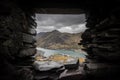 Beautiful view of mount Snowden landscape through window of abandoned miners bothie cottage in Dinorwic slate quarry North Wales. Royalty Free Stock Photo