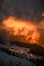 Beautiful view of mountain landscape with snow-cowered trees, glowing sunlit, during sunset. Royalty Free Stock Photo