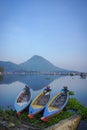 Beautiful view with mountain reflection and fisherman boats on the lakes