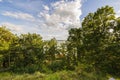 Beautiful view from mountain to nature with a view of the Baltic Sea. Tops of green forest trees on blue sky, Royalty Free Stock Photo