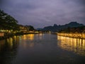 Beautiful view of nam song river with riverside restaurant and the mountain in the night at Vangvieng city Lao. Royalty Free Stock Photo