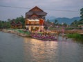 Beautiful view of nam song river with riverside restaurant and the mountain in the night at Vangvieng city Lao. Royalty Free Stock Photo