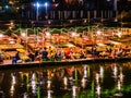 Beautiful view of nam song river with Tourist on riverside restaurant and the mountain in the night at Vangvieng city Lao Royalty Free Stock Photo