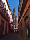Beautiful view of narrow alley in the historic center of town Arucas, Gran Canaria, Spain with people sitting in cafe.