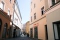 Beautiful view of a narrow street between beige houses, cozy courtyards in the city center