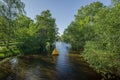 Beautiful view of nature landscape. Small river with big green trees on both sides. Royalty Free Stock Photo