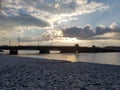 Beautiful view of the Neva embankment. In the background blurred sunset, bridge, clouds