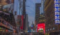 Beautiful view of night Broadway with advertising television screens against background of night sky. New York.